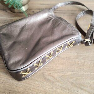 Dawli metallic pewter color crossbody bag with decorative stitching on the side